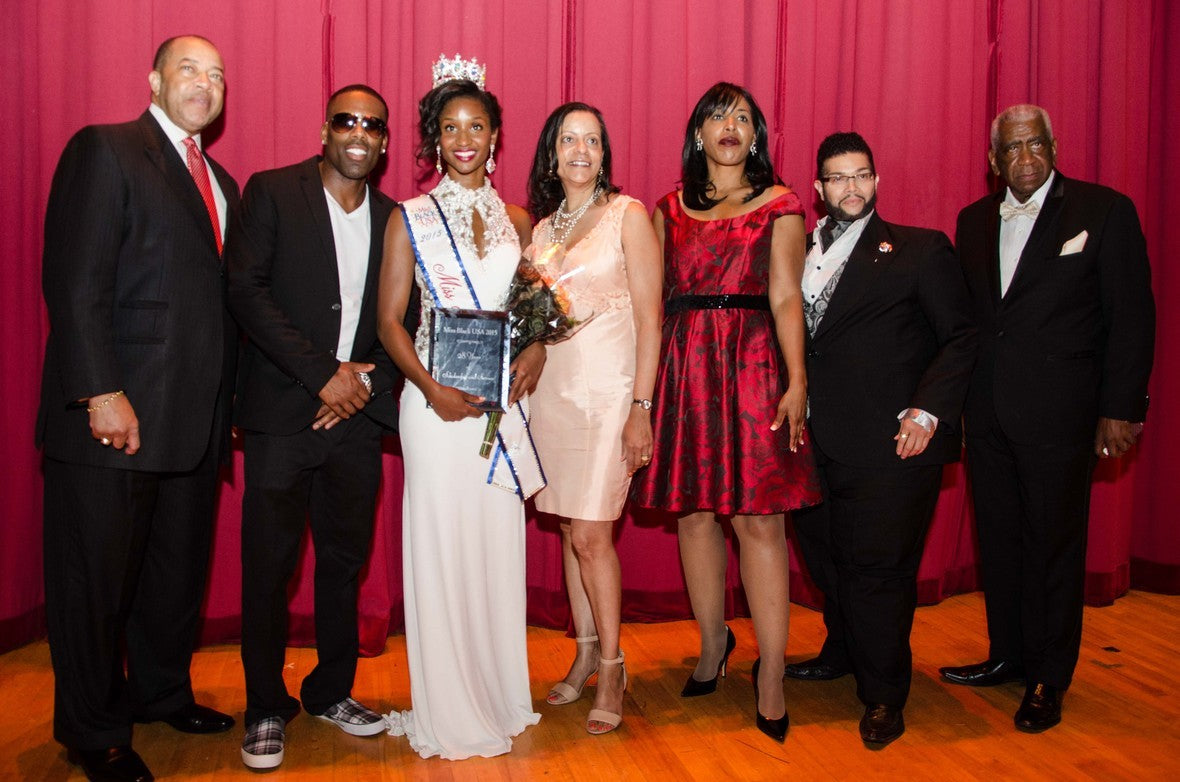 In photo: Miss black USA executives, judges, Pageant winner Madison Gibbs & K Michael pose for media.